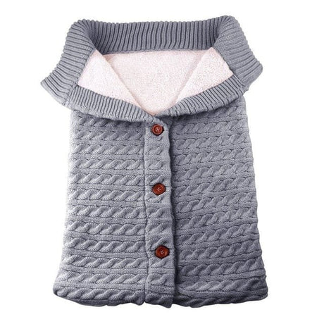 Gray knitted dog coat with buttons.