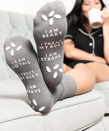 Non-slip birth affirmation hospital socks in gray with grip soles for safe hospital walking.