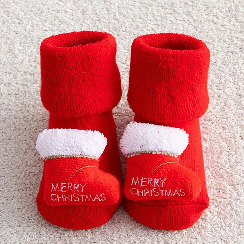 Non-slip Cotton Kids Socks in red Merry Christmas fur-trim booties on light background for holiday gifting.