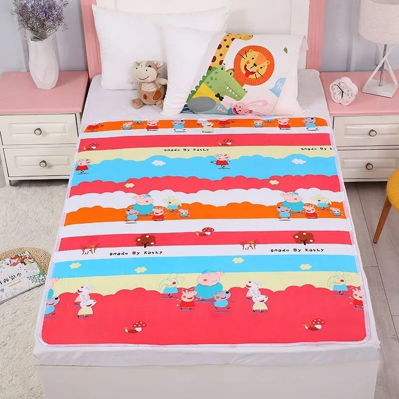Children's bed with colorful cartoon-themed bedding in a bedroom setting.