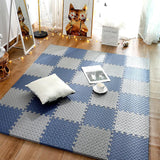 Checkered blue and gray rug on a wooden floor with a white pillow and small table.