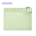 Light green silicone mat with multiple compartments.