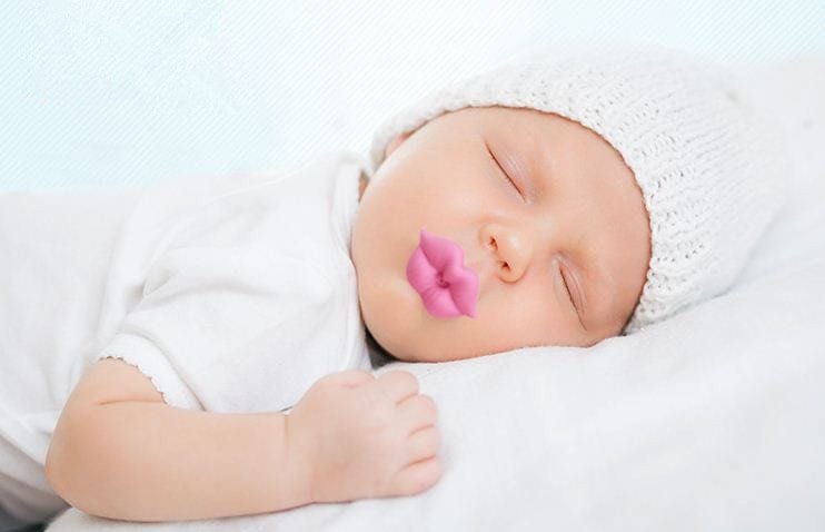 Red Kiss Lips Baby Pacifier used at nap time to settle newborns and add a playful touch to sleepy photos.