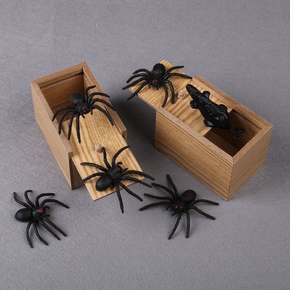 Novelty wooden spider jump scare prank box opened to show the hidden spider used for surprise jokes.