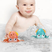 Octopus Clockwork Bath and Beach Toy wind-up water toy used by a baby for splashing fun during bath time and pool play.
