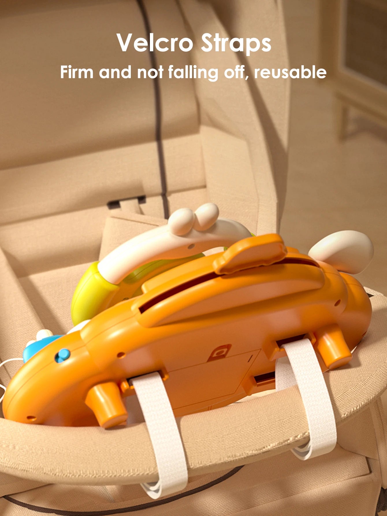 Orange steering wheel toy attached to a car seat with straps for backseat pretend play.