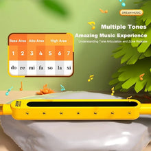 Yellow Otamatone tadpole synthesizer with tone guide chart for teaching kids pitch, notes, and simple music practice.