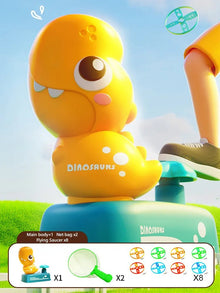 Yellow dinosaur toy with a blue base on a grassy field with a blue sky.