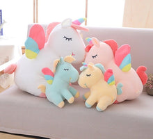 Set of colorful unicorn-shaped cushions on a sofa