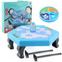 Penguin ice game box beside the ice table, spinner and hammer