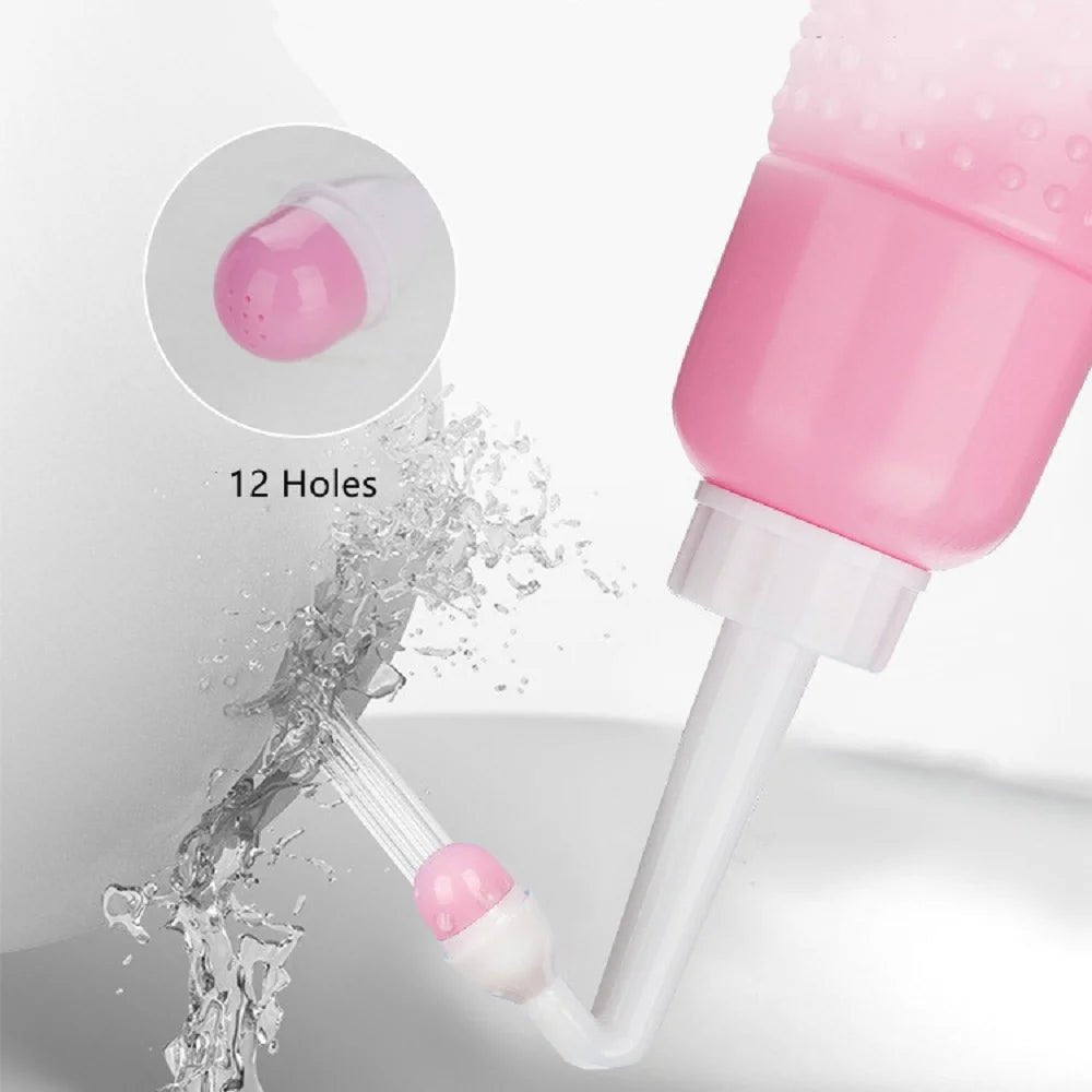 Pink and white Peri Bottle with water splash, used for gentle postpartum perineal cleansing.