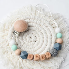 Personalised baby teether and dummy clip for daily nursery use, keeping soothers attached during play and naps.