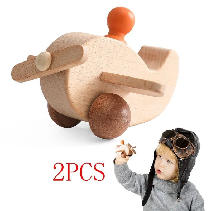 Child wearing a pilot hat playing with the airplane piece from a Montessori wooden train and trolley toy set.