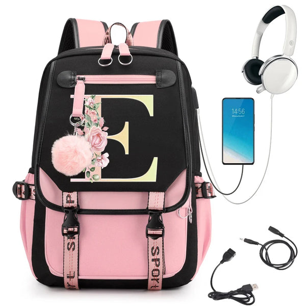Pink and black backpack with floral 'E' design, smartphone, headphones, and USB cable.