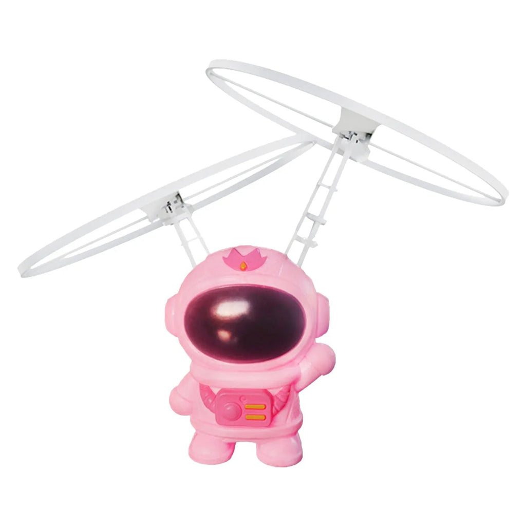 Pink astronaut-design helicopter drone controlled by hand gestures for interactive outdoor play.