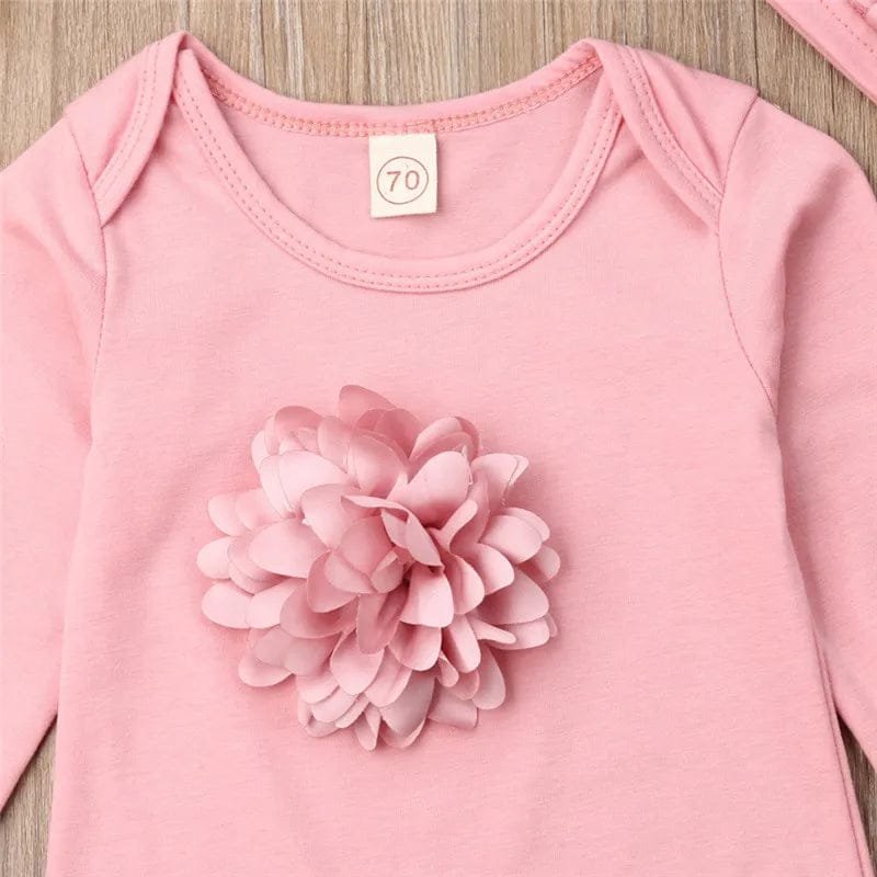 Pink baby onesie with large flower applique detail, a soft cotton jumpsuit for everyday newborn comfort.