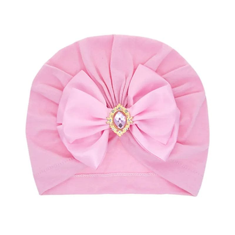 Pink baby turban with a large bow and centre jewel for photoshoots, birthdays, and everyday styling.