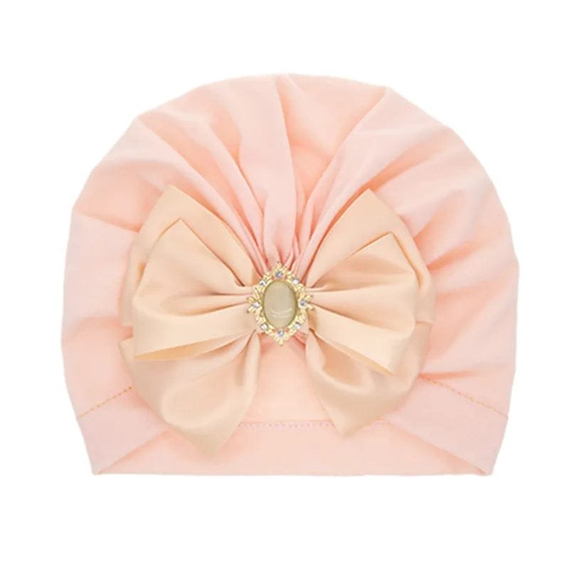 Pink bowknot baby turban cap with decorative front detail for parties, baby showers, and daily cute looks.