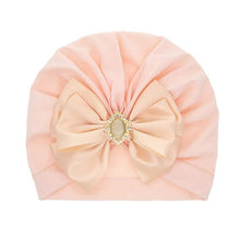 Pink bowknot baby turban cap with decorative front detail for parties, baby showers, and daily cute looks.