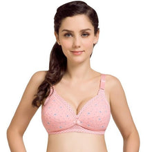 Woman wearing a pink bra with floral patterns on a white background