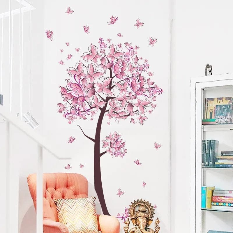 Pink butterfly and flower tree wall decal applied to a white wall for nursery decorating and girls bedroom styling.