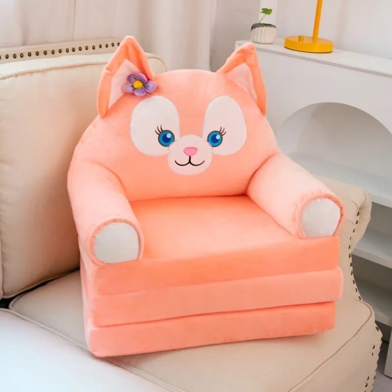 Pink cat plush stuffed animal baby support seat shown on a white couch for nursery seating.