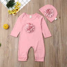 Full outfit display of the pink floral baby jumpsuit and hat set, cotton clothing for warm-weather newborn wear.