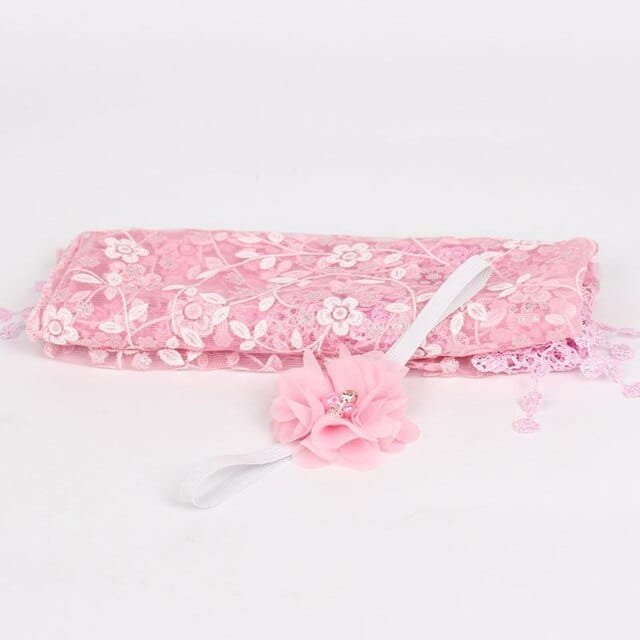 Pink floral newborn headband with bow as a baby photo shoot prop for girls portraits and keepsakes.