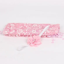 Pink floral newborn headband with bow as a baby photo shoot prop for girls portraits and keepsakes.