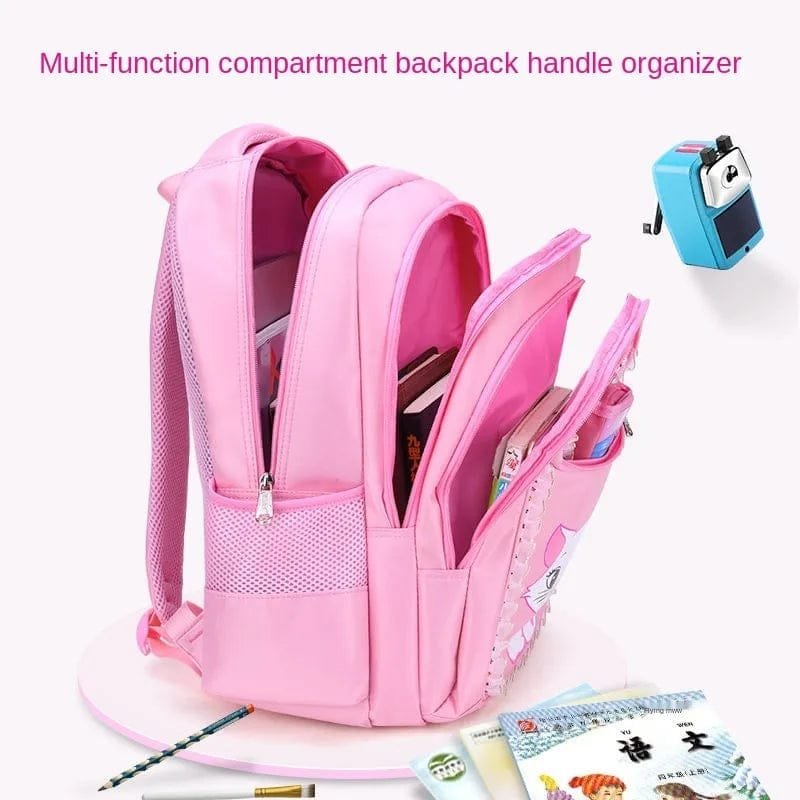 Open compartments of the pink girls backpack showing storage for books, folders, and stationery at school.