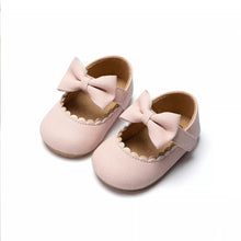 Pink infant bowknot Mary Janes with a soft upper and non-slip sole for tender feet.