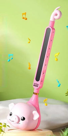Pink Otamatone tadpole piano toy with singing mouth feature for playful sound effects and kids music fun.