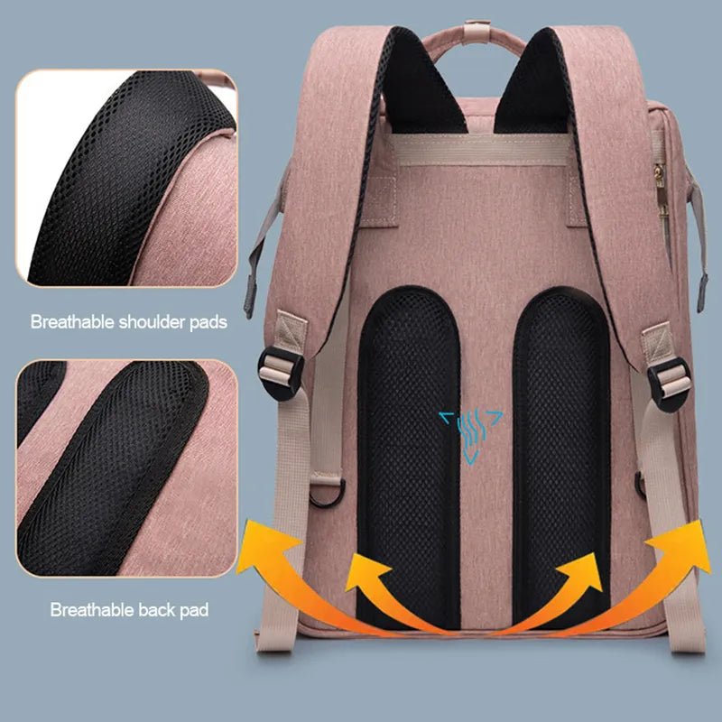 Baby diaper backpack with portable crib in pink featuring breathable padded shoulder straps for daily wear.