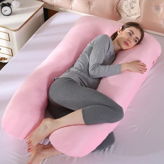 Pink U shaped pregnancy body pillow for bedroom lounging and back support while watching TV or reading.