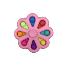 Pink push pop fidget spinner with beads for calming hand movement and stress relief.