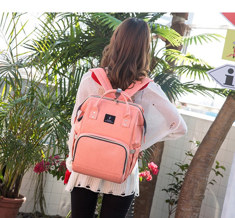 USB Interface Diaper Bag pink backpack with bottle pockets and a wet-dry section for nappy changes.