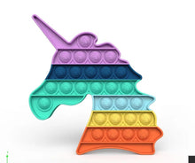 Colorful pop-it toy shaped like a unicorn on a white background