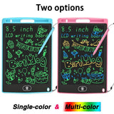 Two LCD writing boards, one blue and one pink, with colorful text and drawings.