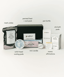 Postpartum care essentials from the recovery box laid out for soothing, cleansing, and daily healing support.