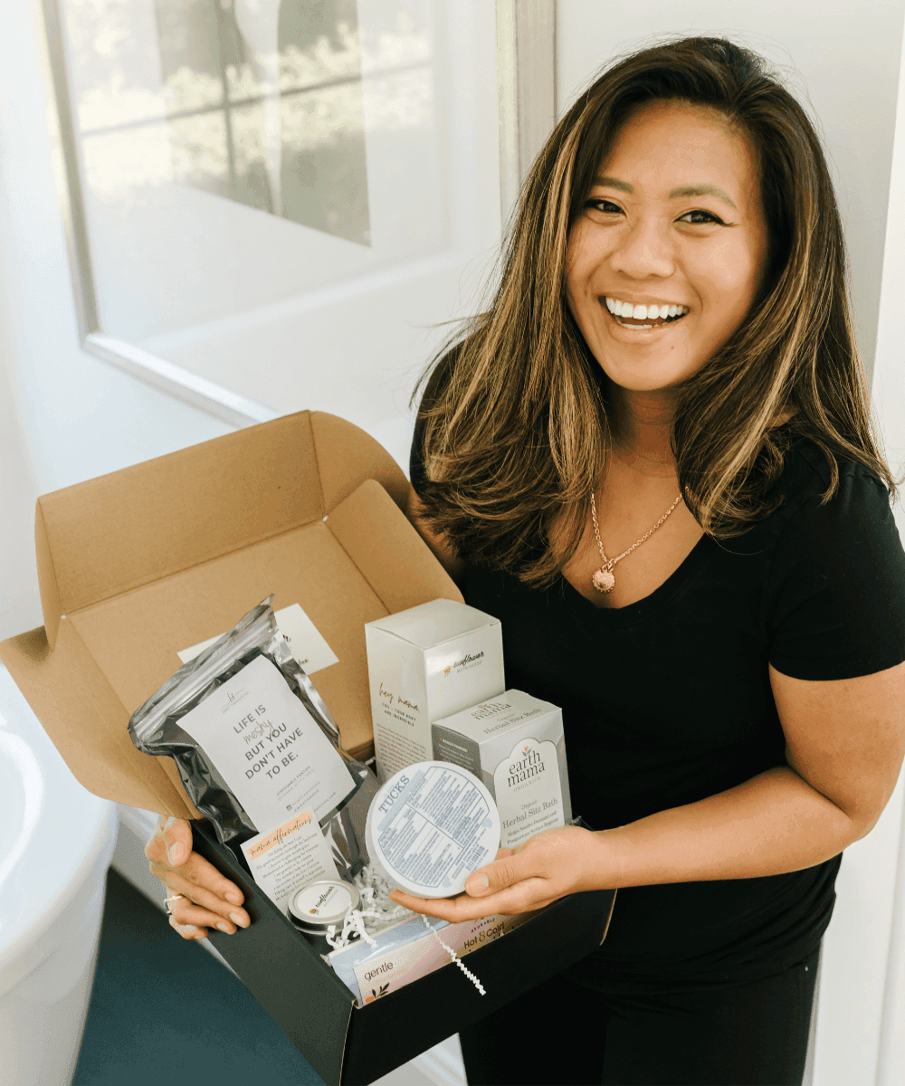 Woman holding a box of skincare products in a bathroom setting