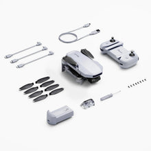 Potensic ATOM Mini Drone accessory layout with spare propellers and battery for extended flight time on filming trips.