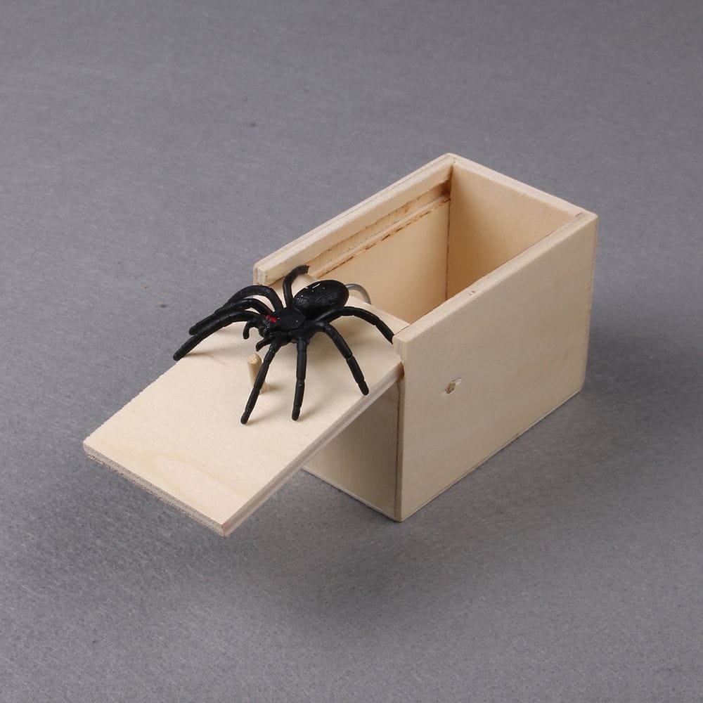 Wooden mousetrap with a black spider toy