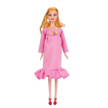 Pregnant mom doll in a pink dress with yellow bow for imaginative play and doll display.