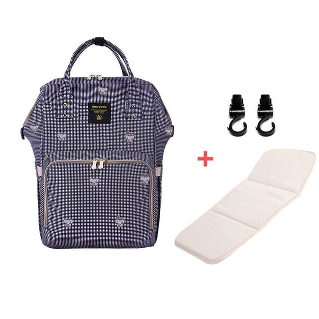 Navy blue backpack with white patterns, white cushion, and black clips 
