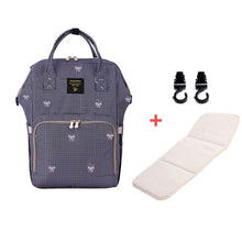 Navy blue backpack with white patterns, white cushion, and black clips 