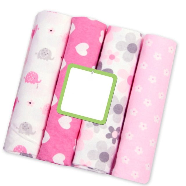 Flat lay of premium muslin baby blankets in pink prints, a 4-pack for baby girl swaddling and newborn photo sessions.