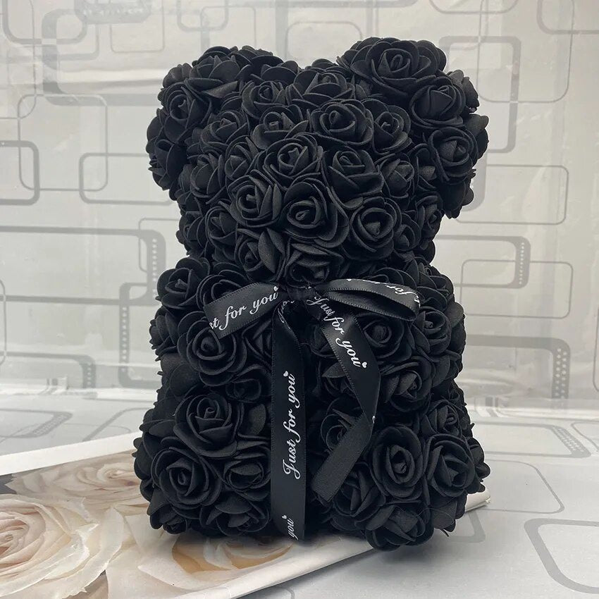 Black rose teddy bear with a black ribbon.