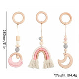 Three wooden baby teething toys with colorful beads and tassels.