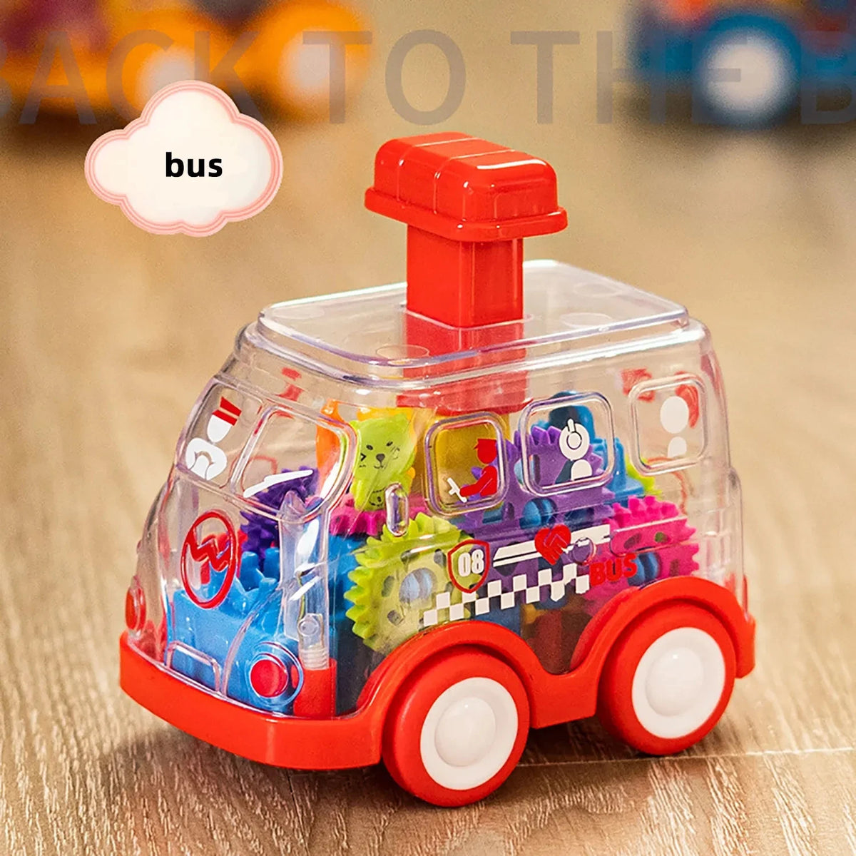Red transparent bus gear toy car with a press button and colorful gears