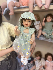 Princess Betty 55CM silicone Reborn Baby Doll held in hand to show full body size and weight for realistic cuddling and doll collecting.